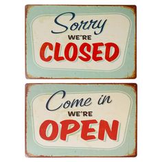 two signs that say sorry we're closed and come in open, sorry we're closed