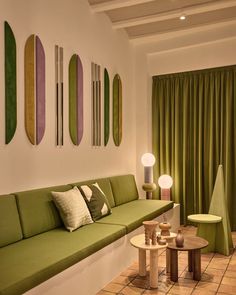 a living room filled with furniture and green curtains