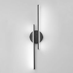 a black and white photo of a wall light