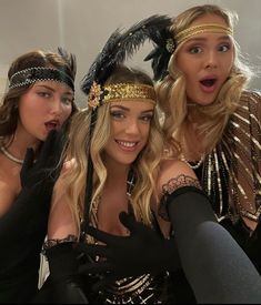 three women dressed up in costumes posing for the camera