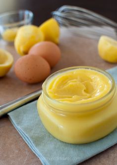 a jar of mayonnaise sitting on top of a table next to some eggs