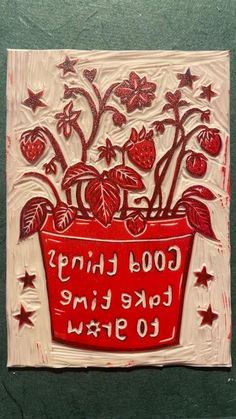 a red vase with flowers and stars on it that says good things take time to grow