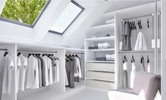 a white closet filled with lots of clothes