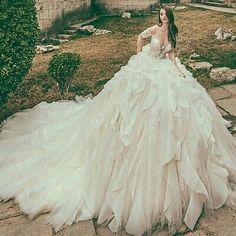 a woman in a wedding dress sitting on the ground