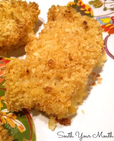 two pieces of fried chicken sitting on top of a plate