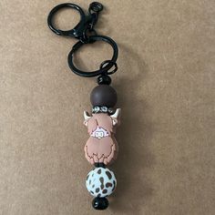 a keychain with a cartoon character hanging from it's side on a brown surface