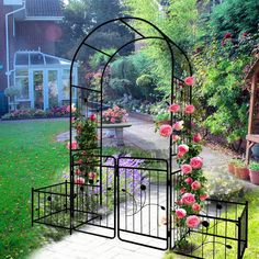 an iron gazebo with pink roses growing on it