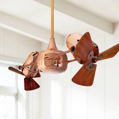 a ceiling fan with three wooden blades attached to it's blades and two metal propeller blades