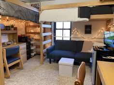 a loft bed is in the middle of a living room