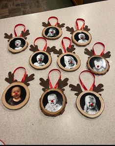 a group of christmas ornaments hanging on a counter top next to a baby's head