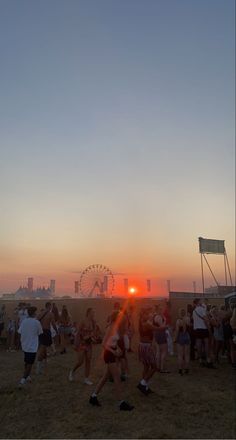 the sun is setting at an outdoor event