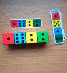 two dominos are sitting next to each other on a wooden table with one missing