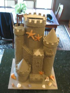 a castle made out of sand sitting on top of a table