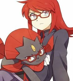 a woman with red hair and glasses holding a cat