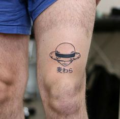 a man with a tattoo on his leg that has an image of the moon and saturn