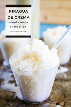 two small cups filled with ice cream on top of a wooden table