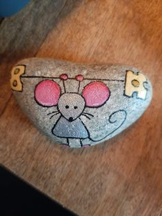 a rock with a mouse painted on it