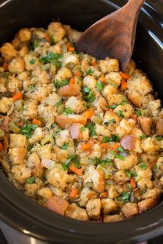 a crock pot filled with stuffing and vegetables