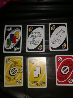 four different stickers on the back of a black suitcase with white and yellow lettering