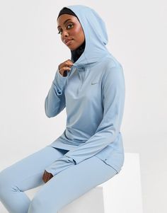 Stay covered when you train in this women's Running Modest Swift Hoodie by Nike. In a Light Armory Blue colourway, this hoodie is made with smooth, stretch-woven polyester for lasting comfort. It's crafted with Dri-FIT tech to wick away sweat, and delivers UV protection from the sun. It features a quarter zip fastening with a fixed hood to keep you covered when you need it, and zips at the side seams to amp up your airflow. It has thumb loops for a secure, streamlined fit as you move, and a watch window to track your miles. Finished with Nike Swoosh branding at the chest. Machine washable. Nike Sweats, Student Discounts, Buy Now Pay Later, Workout Hoodie, Jd Sports, Nike Running, Running Women, Black Nikes, Quarter Zip