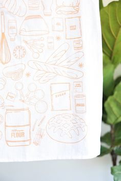 a tea towel with an image of food on it and the words flour written in orange ink