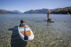 two people are standing on surfboards in the water