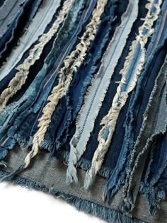 an old pile of blue jeans with torn edges