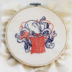 an octopus with a red scarf on it's head is in the middle of a cross stitch pattern