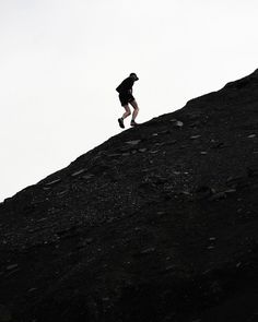 a man running up the side of a mountain