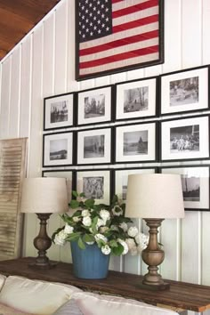 a living room with pictures and flowers on the wall