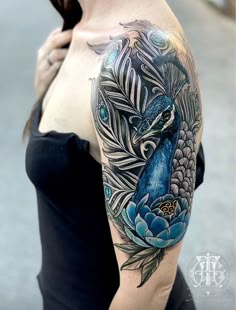 a woman with a peacock tattoo on her arm