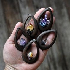 a person holding three rings with different designs on them in their hand, and the other two are made out of wood