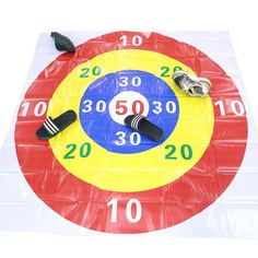 a large clock made out of plastic on top of a white surface with scissors and money