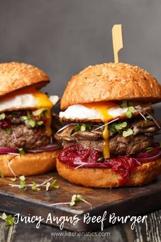 two burgers with meat and cheese on buns