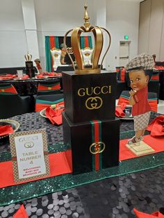 a table topped with black boxes and gold crowns