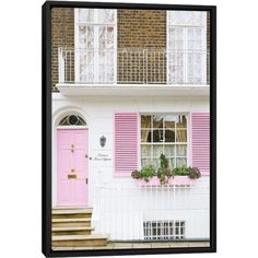 a pink door and window in front of a white house