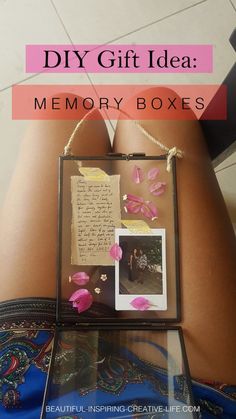 a woman laying on the floor with her back turned to the camera and holding a memory box