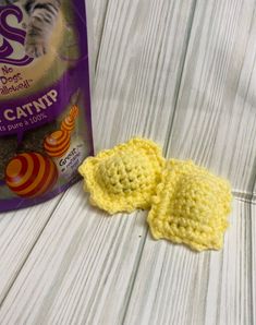 a crocheted catnip next to a bag of catnip