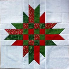 a red and green star quilted on top of a table