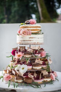 a three tiered cake with flowers on top