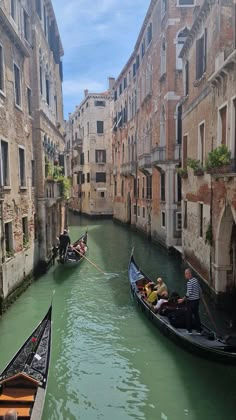 two gondolas in the middle of a narrow canal