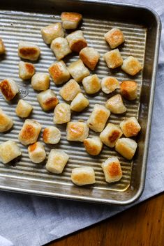 small pieces of bread sitting on top of a metal pan