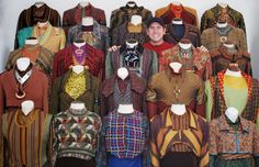 a man standing in front of a display of different colored clothing on mannequins