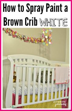 a white crib with pink, yellow and green bedding