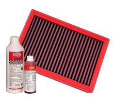 a red air filter next to a bottle of engine oil