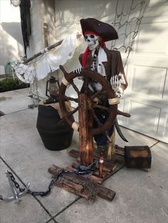 a statue of a pirate with a steering wheel