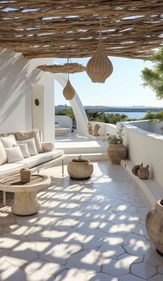 an outdoor living area with white walls and furniture