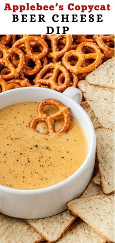 a bowl of beer cheese dip with pretzels on the side