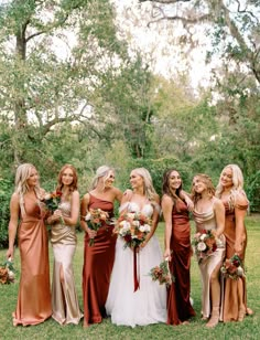 a group of women standing next to each other on top of a lush green field