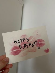 someone holding up a card with the words happy birthday on it